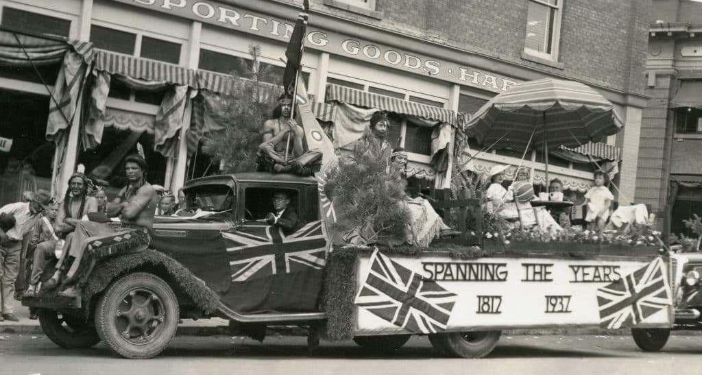 On July 1, 1937, the Hudson’s Bay Company (HBC) float was emblazoned with Union flags and featured employees wearing red-face