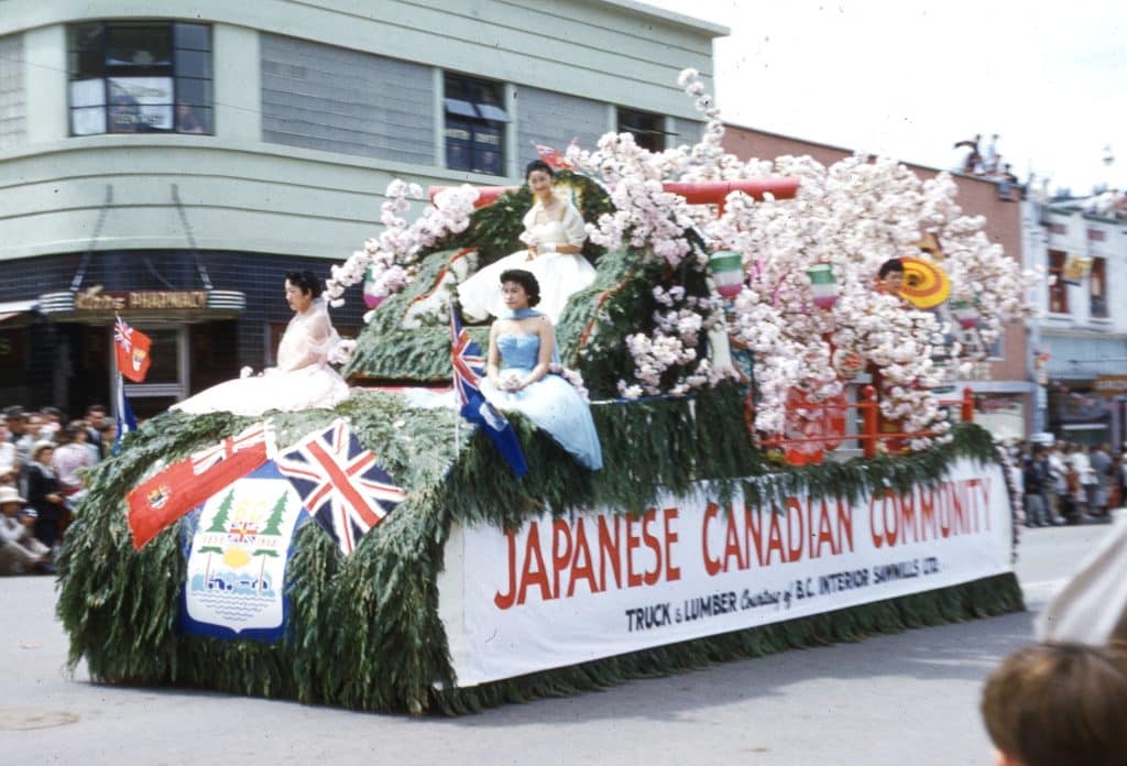 A Japanese-Canadian Community float in the 1956 Kamloops Dominion Day parade features elegantly dressed young women and countless branches of cherry blossoms