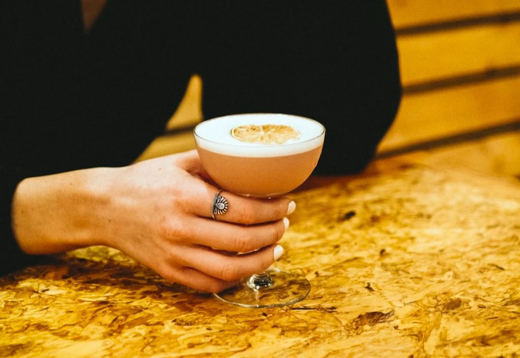 A photo of someone's hand holding a glass where there is a non-alcoholic drink. It is one of the options in Kamloops