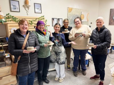 A group of 6 people holding their pottery creations at Kamloops Art Party. Pottery can be a great holiday gift