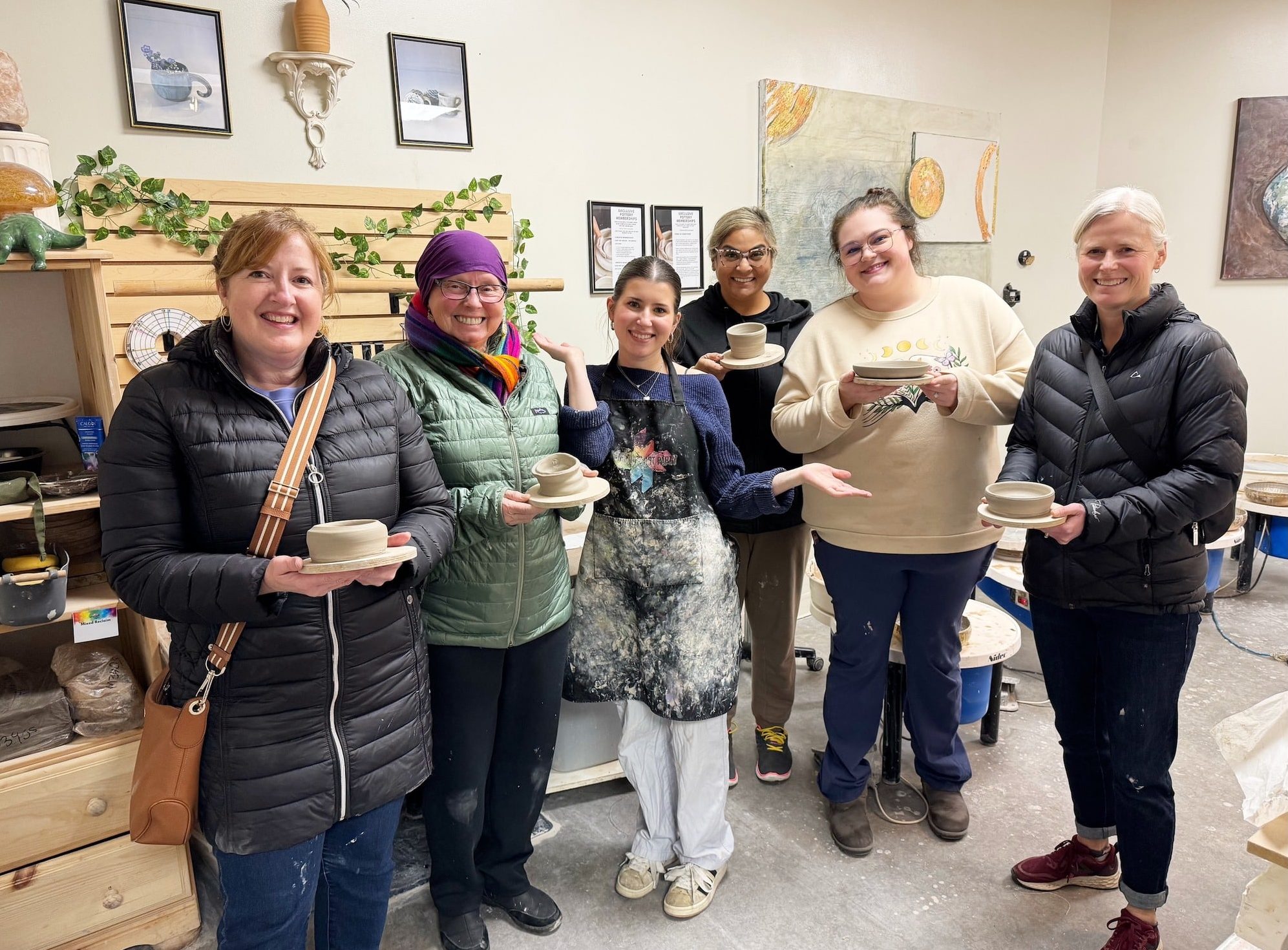 A group of 6 people holding their pottery creations at Kamloops Art Party. Pottery can be a great holiday gift