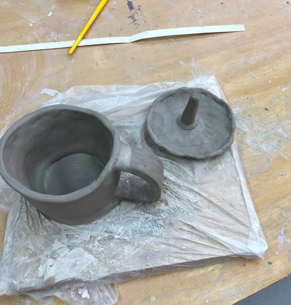 A cup and a ring tray on a table. Pottery can be a great holiday gift