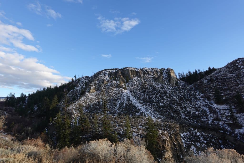 A mountain with snow, there is also vegetation around. The image is there to show the winter season in Tkʼemlúps and the Secwépemc winter traditions