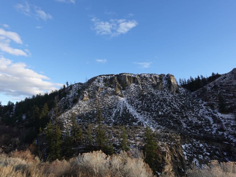 A mountain with snow, there is also vegetation around. The image is there to show the winter season in Tkʼemlúps and the Secwépemc winter traditions