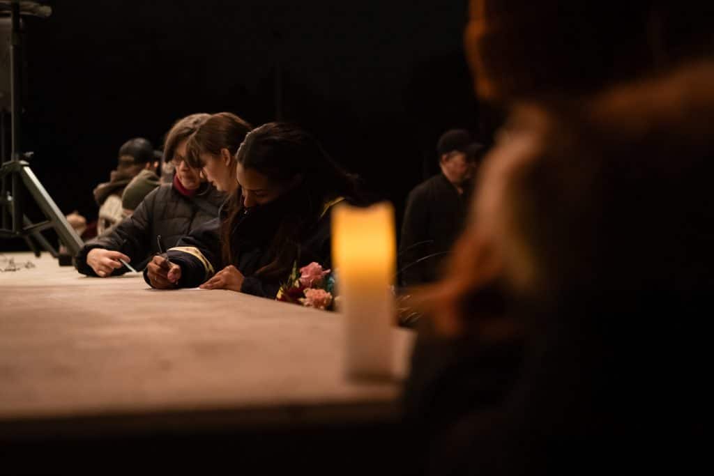 Kamloops community vigil for Muhammad “Ash” Zafar. Folks are gathered and writing messages for Ash's close friends and family 